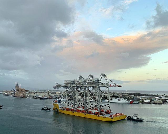 Tugs guide Sand Island cranes into Honolulu Harbor